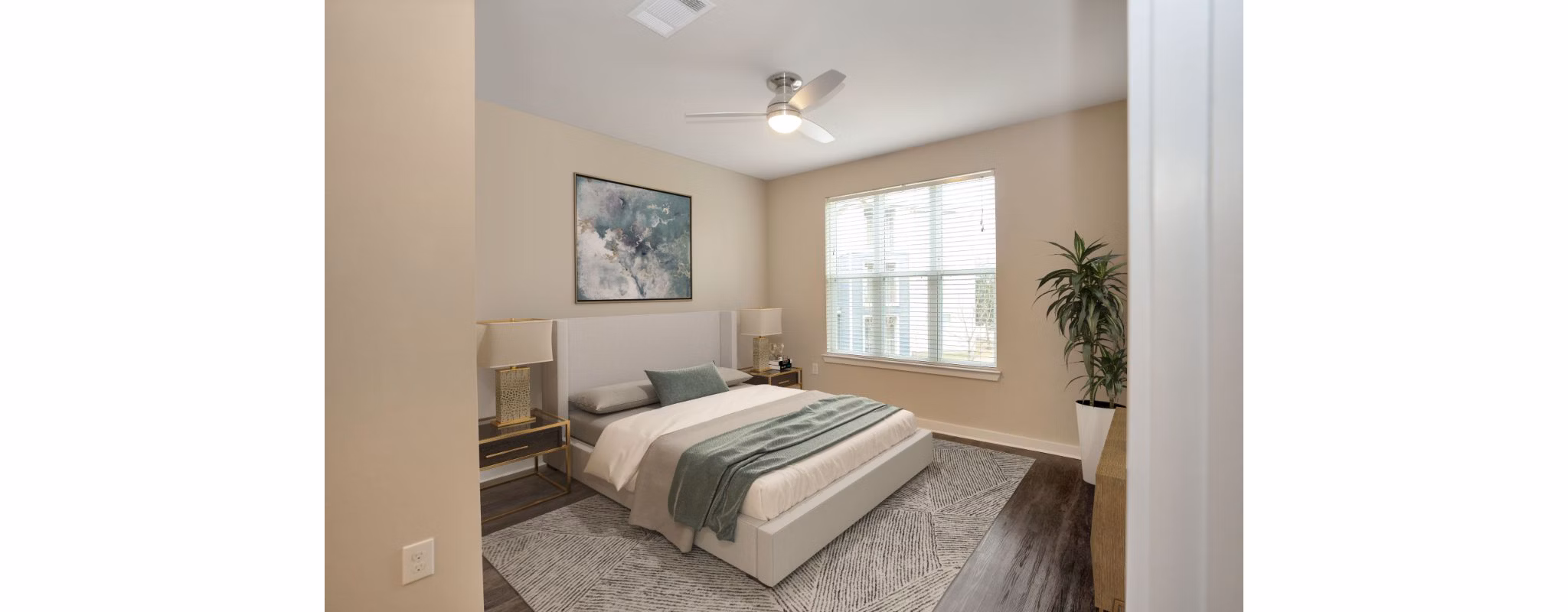 Modern bedroom with king-size bed and large windows in Hays Park Apartments