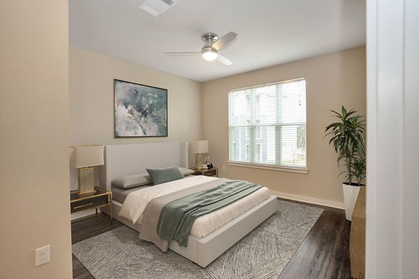 Modern bedroom with king-size bed and large windows in Hays Park Apartments
