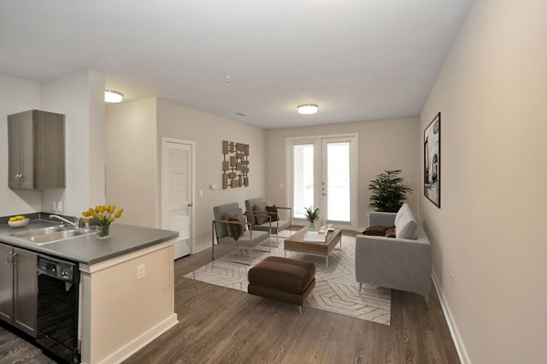 Elegant living room featuring modern decor and hardwood floors in Hays Park Apartments