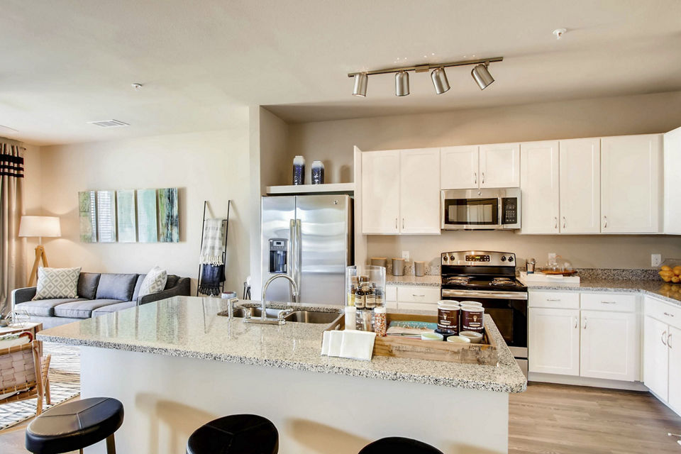 Kitchens with granite countertops and stainless steel appliances in Hays Park Apartments