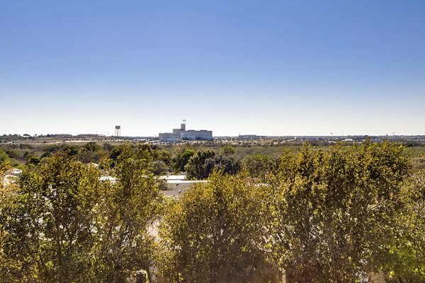 Hays Park Apartments: Serene view of luxury apartment complex surrounded by lush greenery in desirable neighborhood