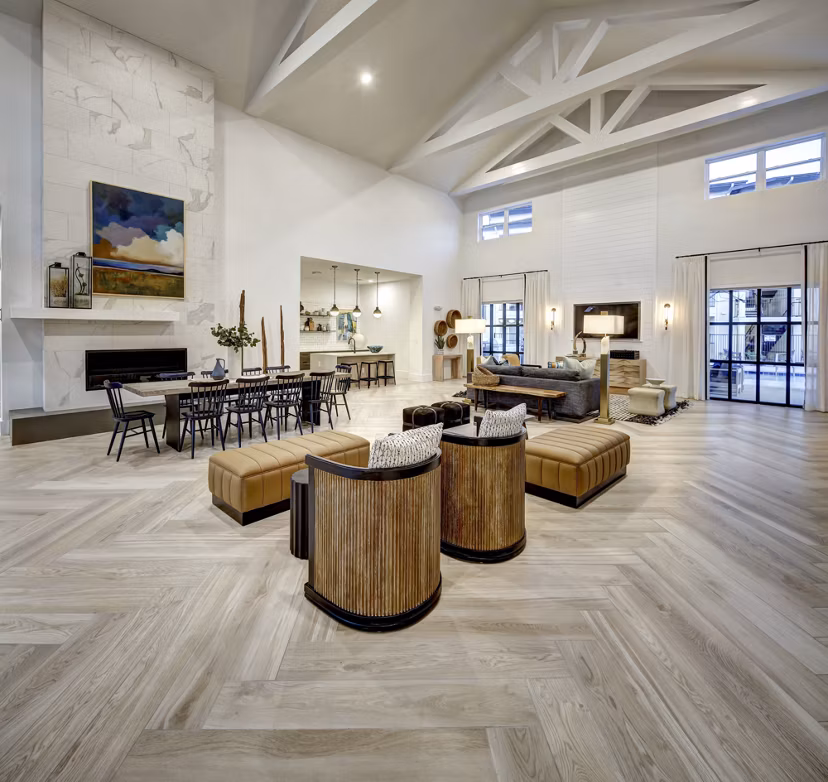 Modern clubhouse with pool tables and seating areas at Leander Park Apartments