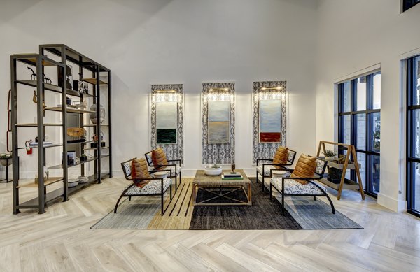 Clubhouse at Leander Park Apartments featuring modern design and ample seating areas in a luxury community setting
