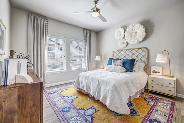 Cozy bedroom with modern furnishings at Wells Park Apartments