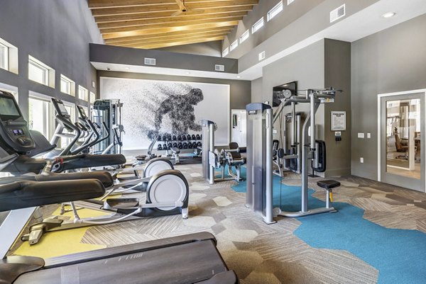 Fully-equipped fitness center with modern machines at Wells Park Apartments, tailored for active lifestyles and convenient workouts