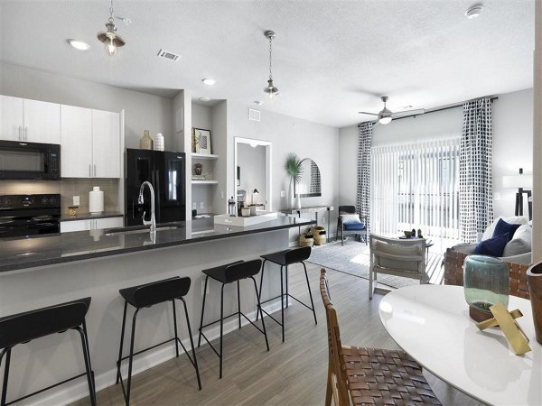 Modern kitchen with stainless steel appliances at Wells Park Apartments