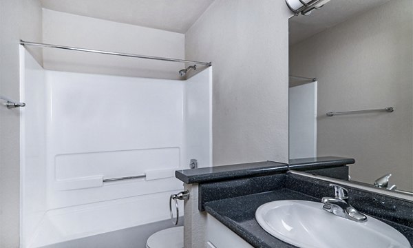 Bathroom featuring modern fixtures and elegant design at Wood Creek Apartments