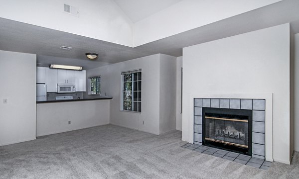 Cozy living room with plush seating and natural light in Wood Creek Apartments, offering luxury and comfort in design