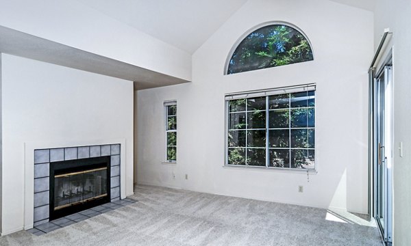 Spacious living room with modern decor at Wood Creek Apartments, featuring cozy seating and ample natural light
