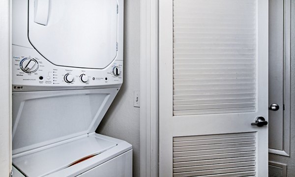 Modern laundry room with energy-efficient washers and dryers in Wood Creek Apartments