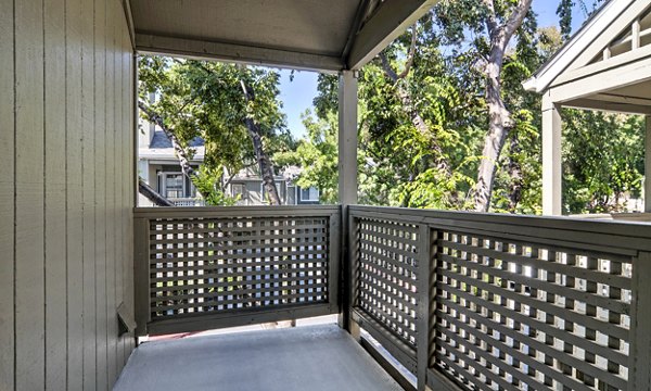 Outdoor patio with seating at Wood Creek Apartments, providing scenic views and stylish outdoor living spaces for relaxation