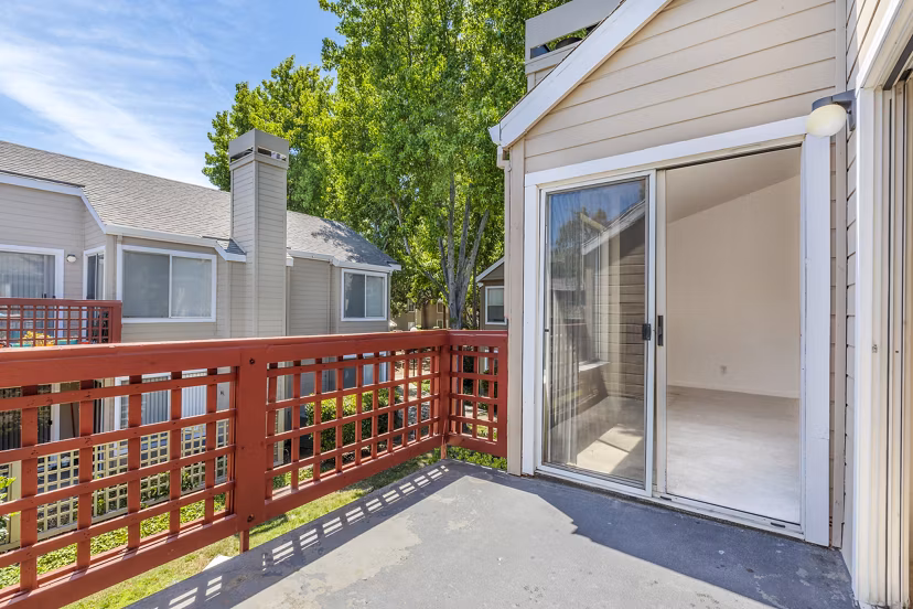 Spacious balcony with outdoor seating at Wood Creek Apartments, ideal for relaxation and views