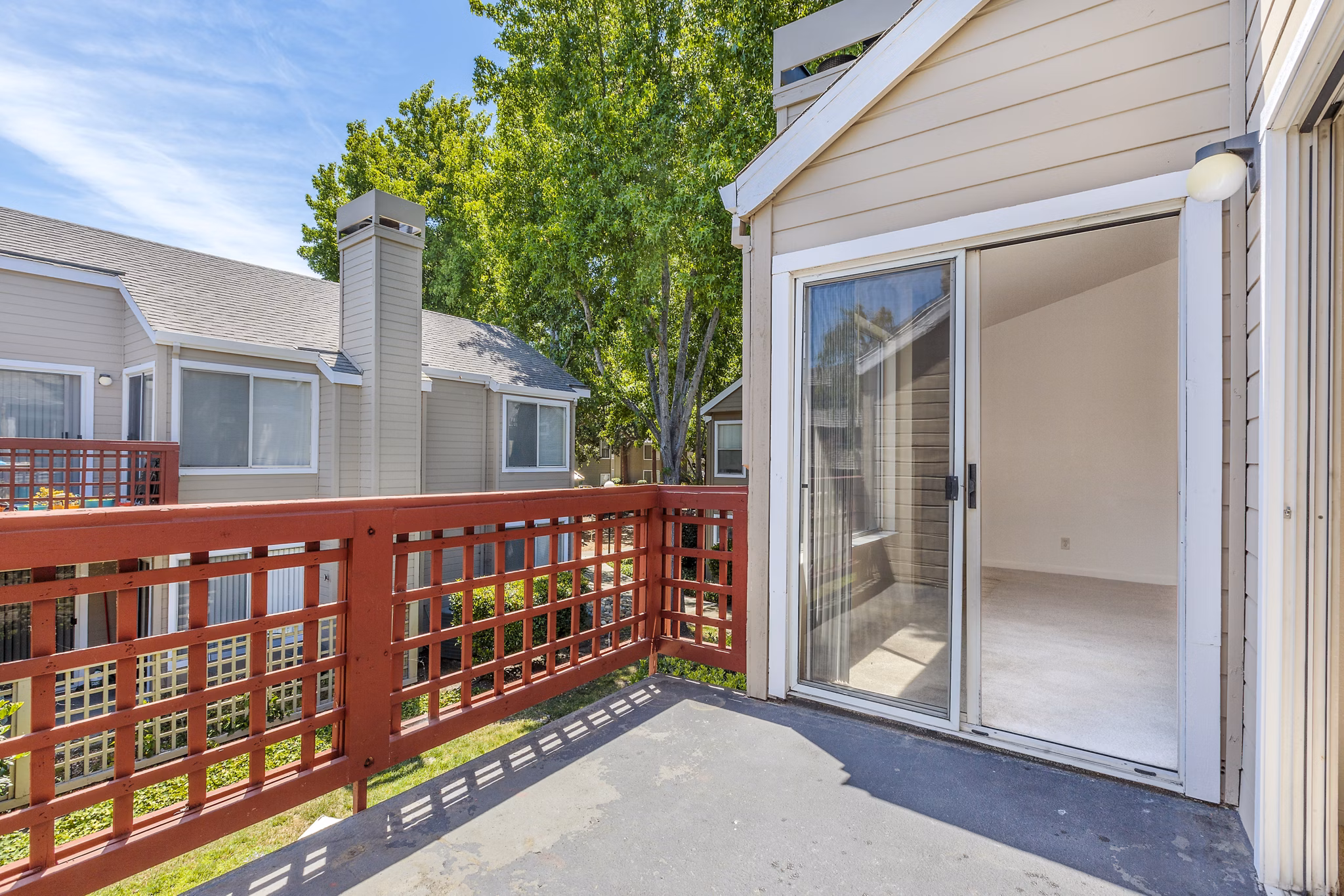 Spacious balcony with outdoor seating at Wood Creek Apartments, ideal for relaxation and views