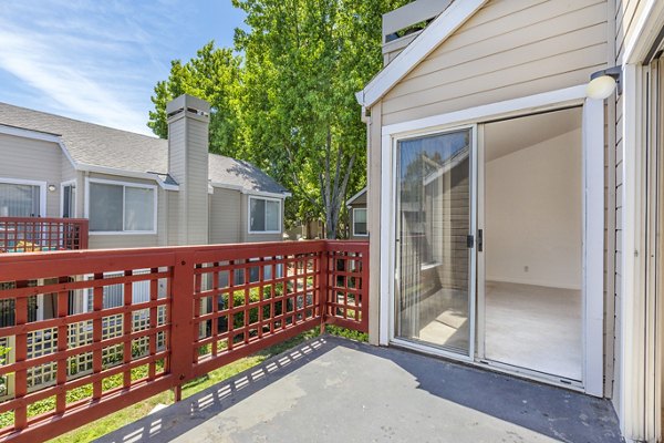 Spacious balcony with outdoor seating at Wood Creek Apartments, ideal for relaxation and views