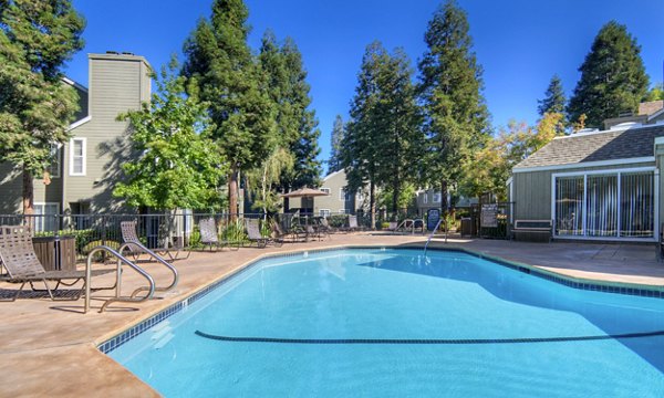 Sparkling outdoor pool at Wood Creek Apartments, a luxury community offering resort-style amenities for relaxation and leisure