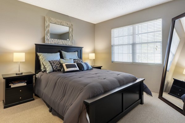 Contemporary bedroom with elegant decor at Vue at Spring Creek Apartments