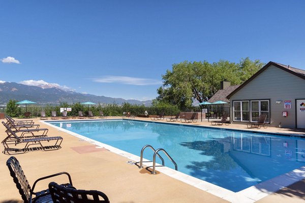 Outdoor pool with luxurious seating at Vue at Spring Creek Apartments