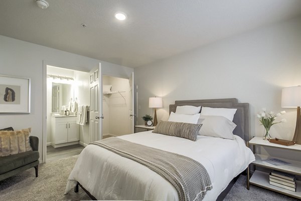 Luxury bedroom with plush bedding at Monarch Meadows Apartments