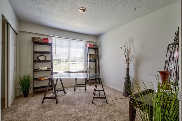 Cozy bedroom with plush bedding at Monarch Meadows Apartments, a Greystar luxury living community in an inviting neighborhood