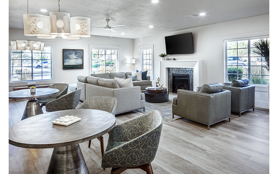 Elegant clubhouse with modern seating and fireplace at Monarch Meadows Apartments, ideal for social gatherings and relaxation