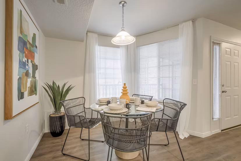 Dining area featuring elegant furniture and modern lighting at Monarch Meadows Apartments