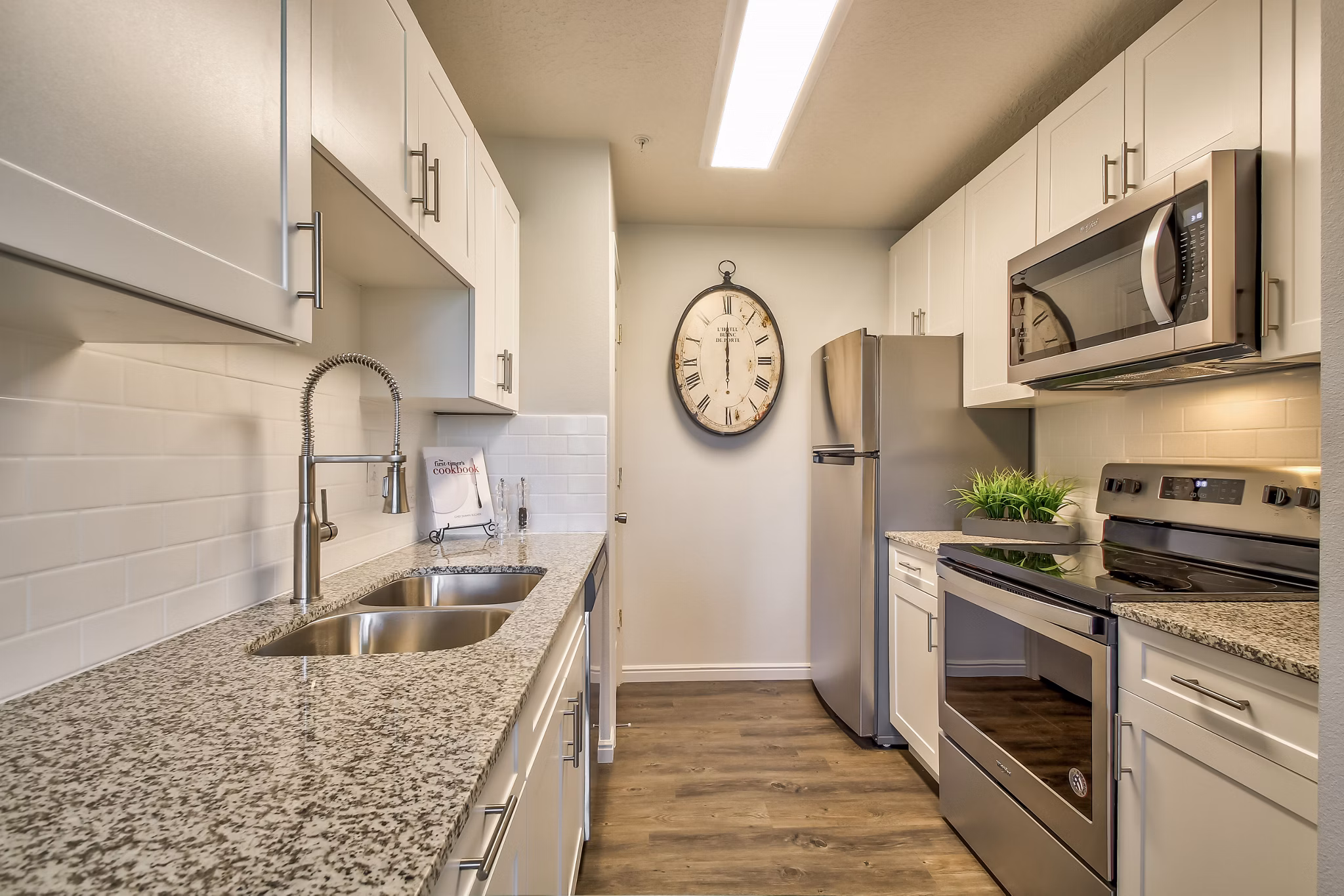 Elegant kitchen with marble countertops and stainless steel appliances in Monarch Meadows Apartments
