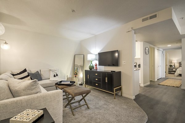 Modern living room with ample seating and natural light at Monarch Meadows Apartments