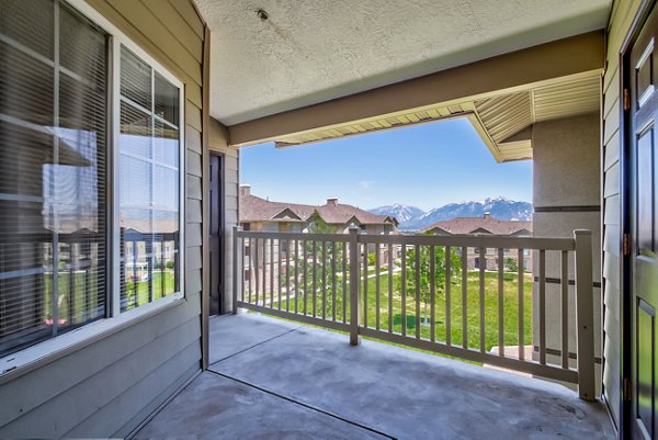 Sunny outdoor patio at Monarch Meadows Apartments with comfortable seating and lush greenery, perfect for relaxation and gatherings