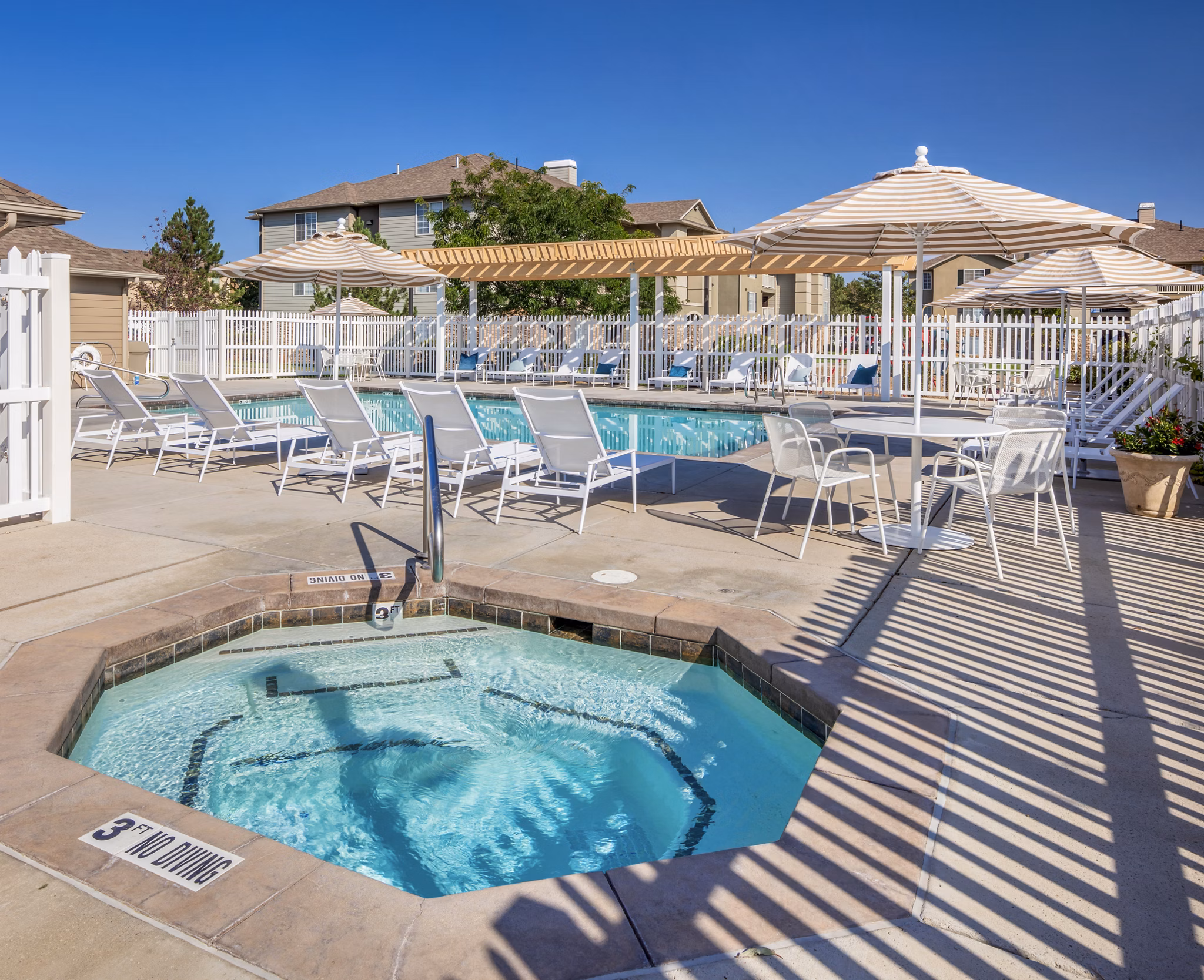 Luxurious pool with lounge seating at Monarch Meadows Apartments