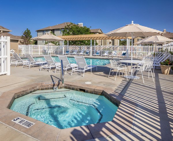 Luxurious pool with lounge seating at Monarch Meadows Apartments