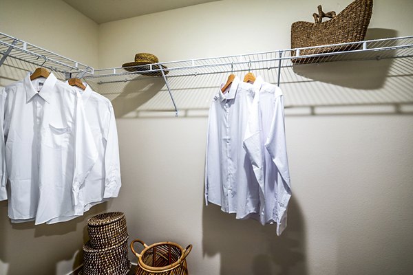 Luxurious walk-in closet with built-in shelving in a bedroom at The Residences at Cota Vera Apartments, ideal for organized living