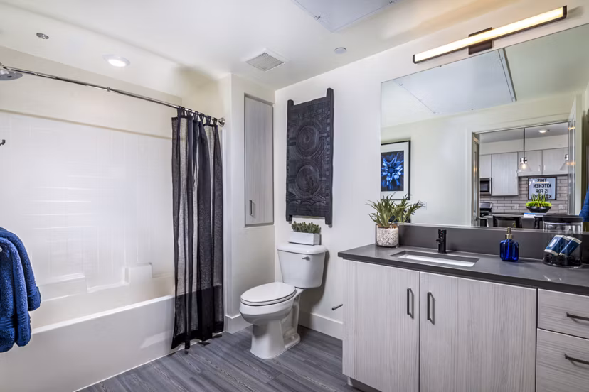 Bathroom with sleek marble countertops and modern fixtures at The Residences at Cota Vera Apartments