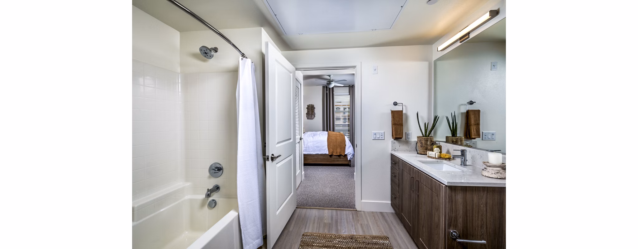 Bathroom with sleek fixtures and large mirror at The Residences at Cota Vera Apartments, Greystar luxury living