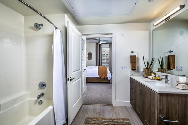 Bathroom with sleek fixtures and large mirror at The Residences at Cota Vera Apartments, Greystar luxury living