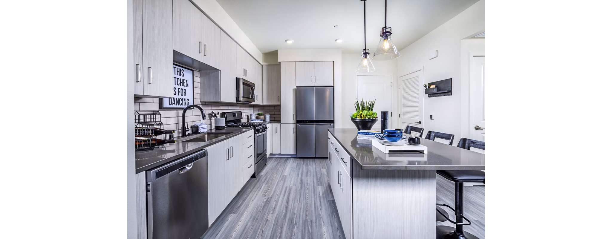 Modern kitchen with stainless steel appliances at The Residences at Cota Vera Apartments