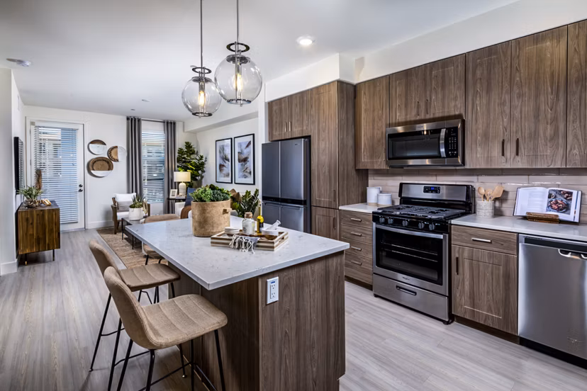 Modern kitchen with stainless steel appliances at The Residences at Cota Vera Apartments