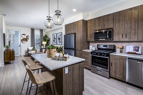 Modern kitchen with stainless steel appliances at The Residences at Cota Vera Apartments