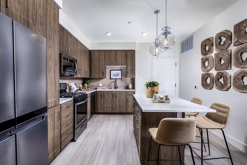 Modern kitchen with stainless steel appliances at The Residences at Cota Vera Apartments