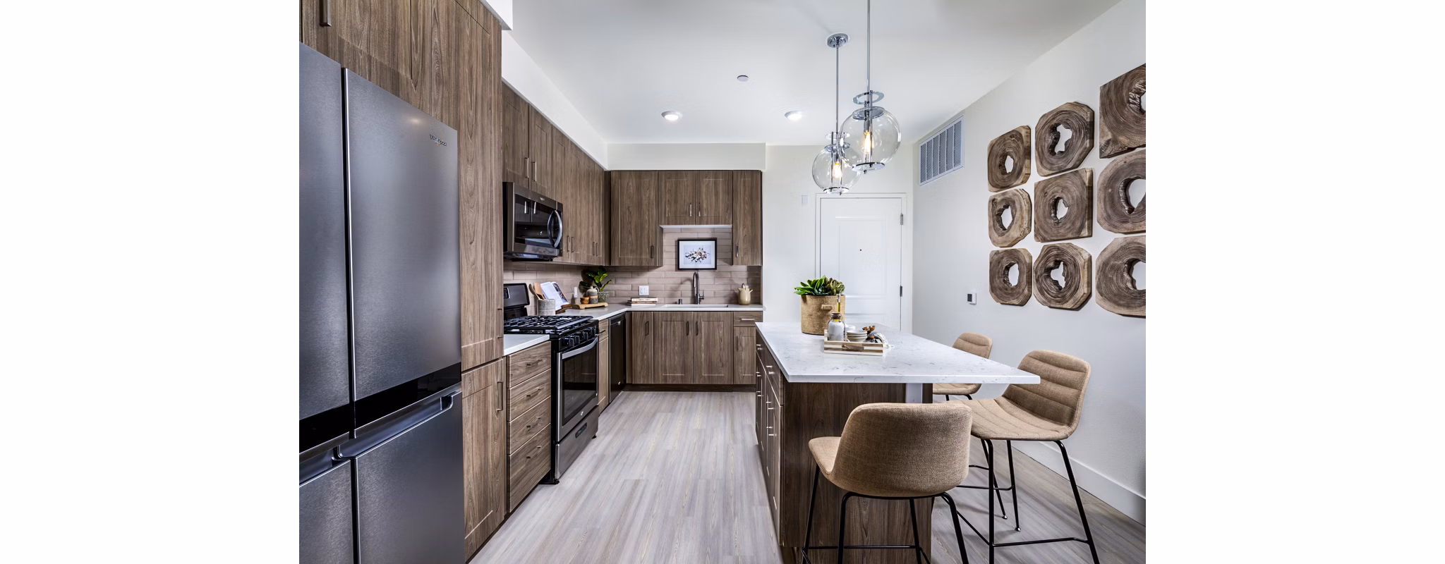 Modern kitchen with stainless steel appliances at The Residences at Cota Vera Apartments
