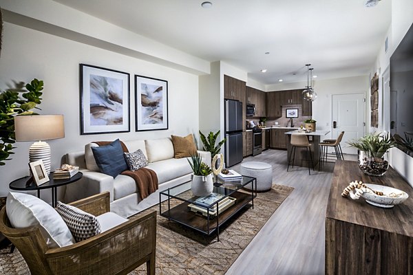 Spacious living room with modern decor and natural light at The Residences at Cota Vera Apartments