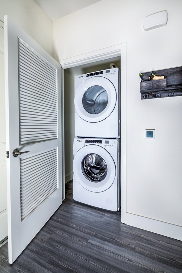 Laundry room featuring state-of-the-art appliances at The Residences at Cota Vera Apartments Perfect blend of function and luxury living