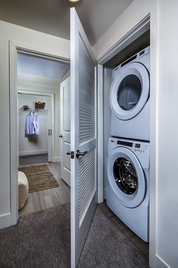 Laundry room at The Residences at Cota Vera, featuring modern appliances and ample storage in a luxury apartment community