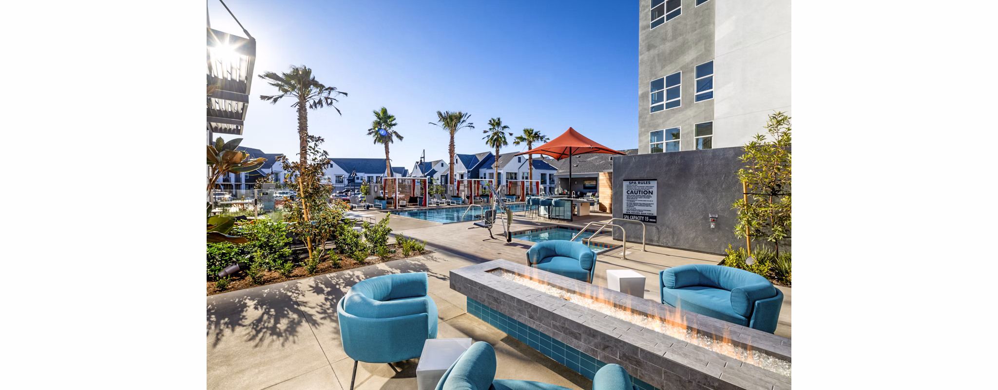 Fire pit area with cozy seating at The Residences at Cota Vera Apartments, offering luxurious outdoor living spaces