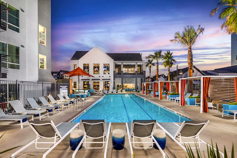 Luxurious pool with lounge chairs at The Residences at Cota Vera Apartments