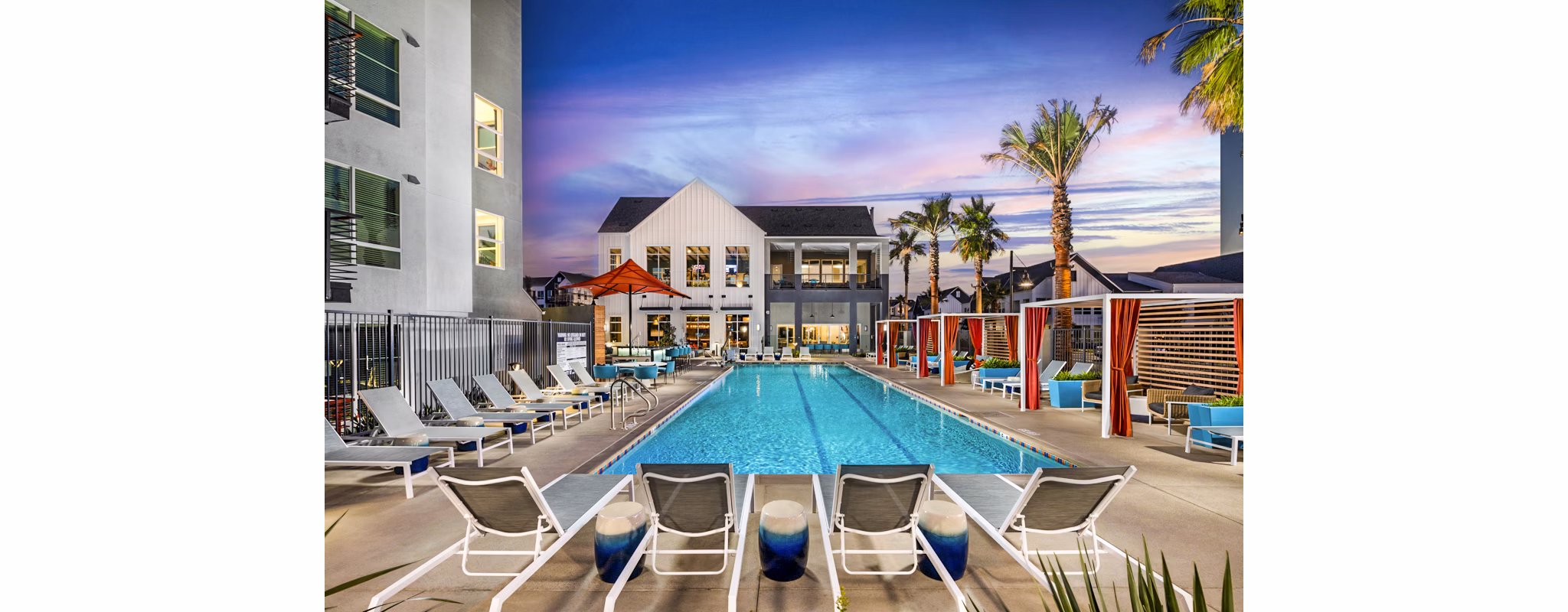 Luxurious pool with lounge chairs at The Residences at Cota Vera Apartments