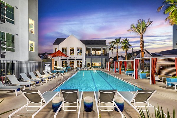 Luxurious pool with lounge chairs at The Residences at Cota Vera Apartments