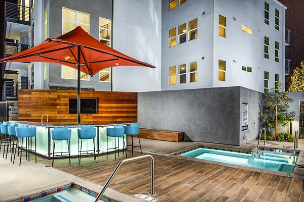 Resort-style pool with lounge chairs at The Residences at Cota Vera Apartments in Chula Vista