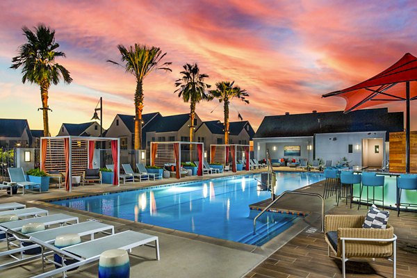 Resort-style pool with lounge seating at The Residences at Cota Vera Apartments