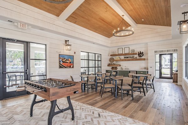 Clubhouse with cozy seating and fireplace at The Heron at River Island Apartments Ideal for social gatherings and relaxation