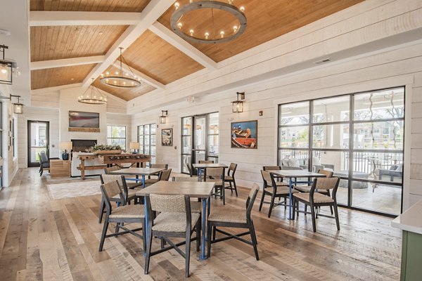 Elegant clubhouse with modern seating and fireplace at The Heron at River Island Apartments